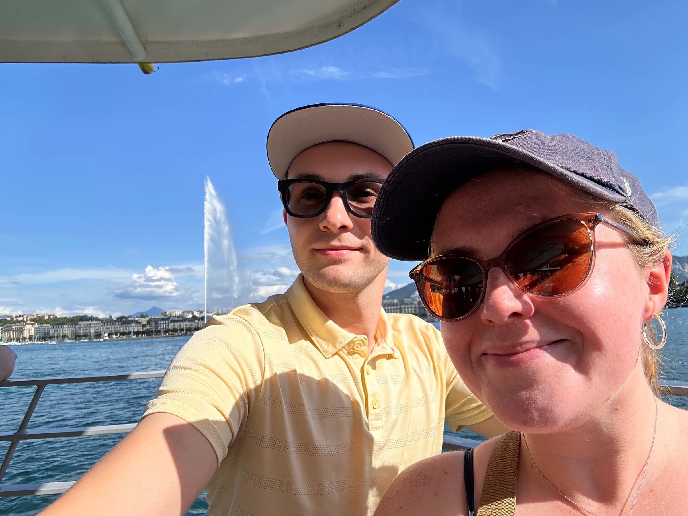 Rachel and Reid on a boat with the Jet d’Eau fountain behind them