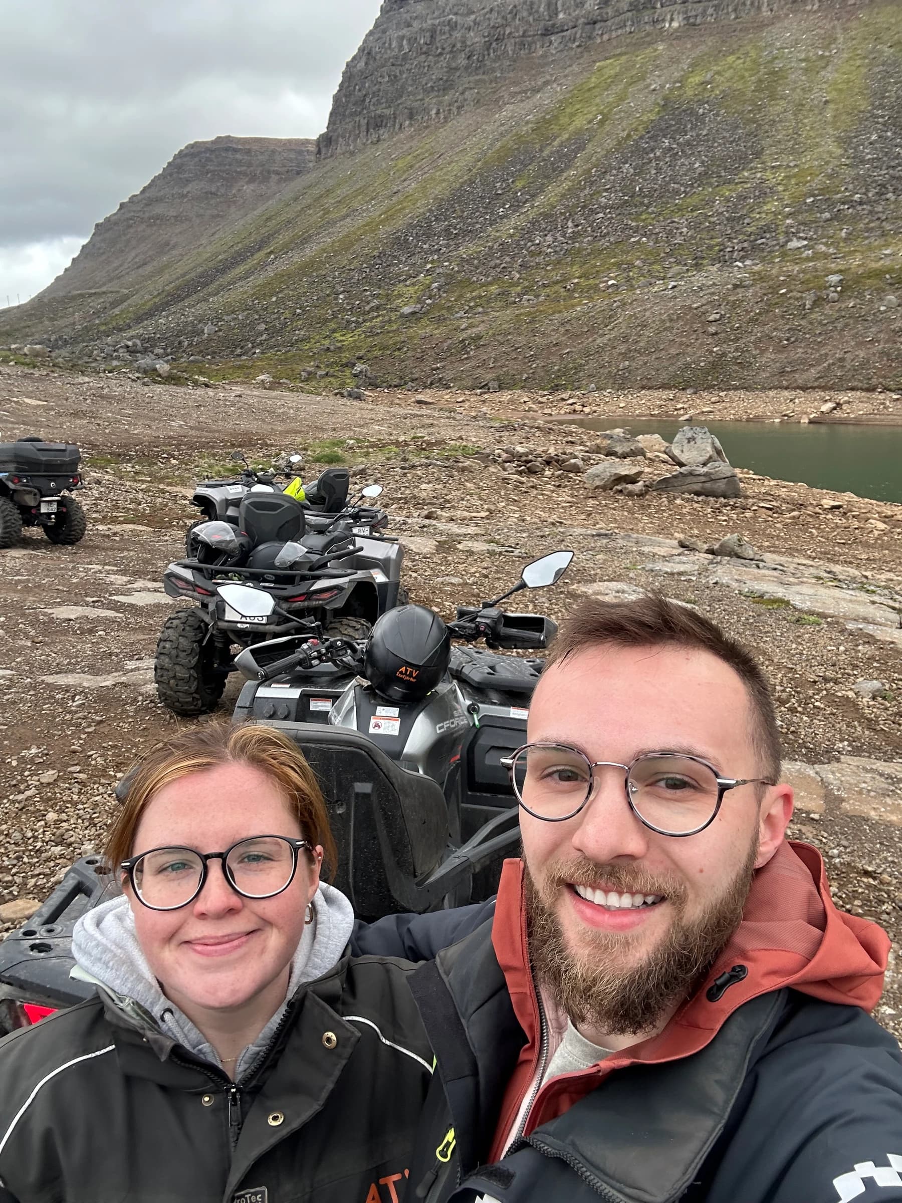 Rachel and Reid on ATVs beside a mountain in Iceland